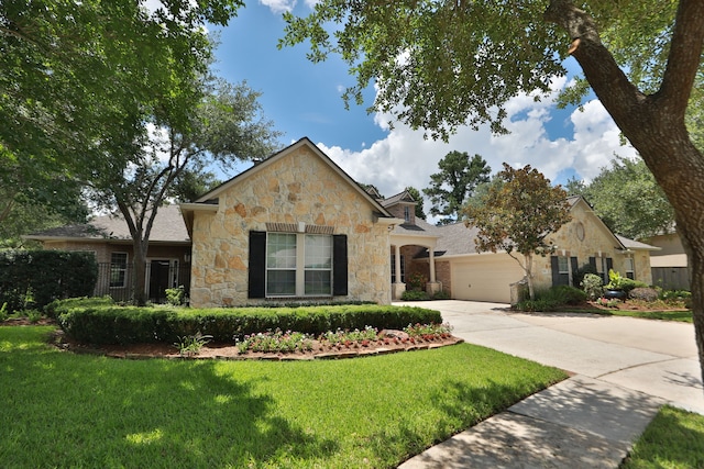 7826 Camden Hollow Ln, Humble, TX 77396 - view of front of home with stone siding, driveway, a garage, and a front yard