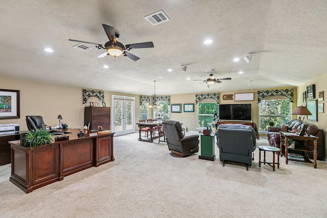 7826 Camden Hollow Ln, Humble, TX 77396 - living area featuring a textured ceiling, a ceiling fan, french doors, an office area, and light colored carpet