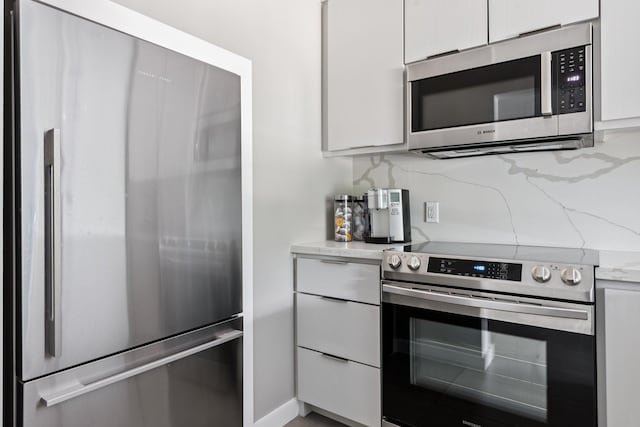 3600 Montrose Blvd Unit 209, Houston, TX 77006 - kitchen with appliances with stainless steel finishes, white cabinetry, and light stone countertops