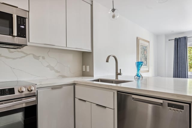 3600 Montrose Blvd Unit 209, Houston, TX 77006 - kitchen with appliances with stainless steel finishes, white cabinets, light stone countertops, decorative backsplash, and modern cabinets