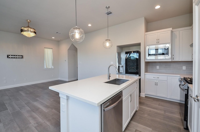 9577 Neuens Rd Unit F, Houston, TX 77080 - kitchen with appliances with stainless steel finishes, wood finished floors, backsplash, light countertops, and recessed lighting