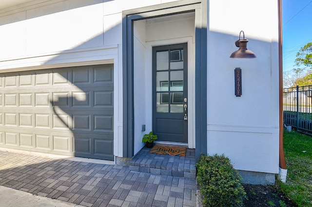 9577 Neuens Rd Unit F, Houston, TX 77080 - entrance to property with a garage, decorative driveway, and stucco siding