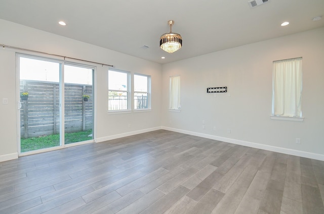 9577 Neuens Rd Unit F, Houston, TX 77080 - spare room featuring wood finished floors and recessed lighting