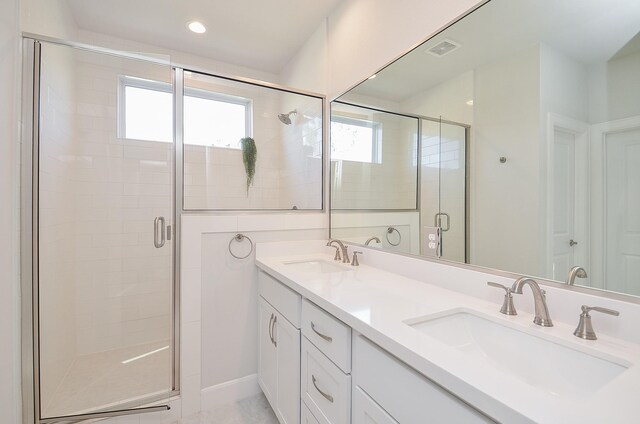 9577 Neuens Rd Unit F, Houston, TX 77080 - bathroom featuring plenty of natural light, a shower stall, and double vanity