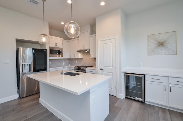 9577 Neuens Rd Unit F, Houston, TX 77080 - kitchen featuring beverage cooler, appliances with stainless steel finishes, under cabinet range hood, decorative backsplash, and dark wood finished floors