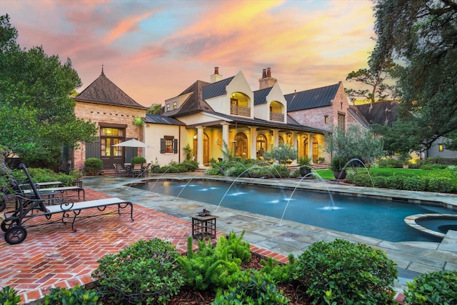 3 E Rivercrest Dr, Houston, TX 77042 - pool at dusk featuring a patio area and a pool with connected hot tub
