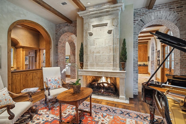3 E Rivercrest Dr, Houston, TX 77042 - sitting room with arched walkways, beamed ceiling, hardwood / wood-style floors, and a fireplace