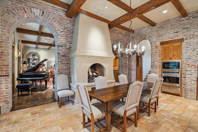 3 E Rivercrest Dr, Houston, TX 77042 - dining area featuring coffered ceiling, beam ceiling, a high end fireplace, a chandelier, and arched walkways