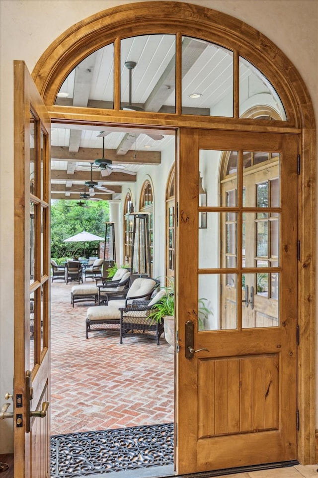 3 E Rivercrest Dr, Houston, TX 77042 - doorway featuring ceiling fan, beamed ceiling, french doors, and brick floors