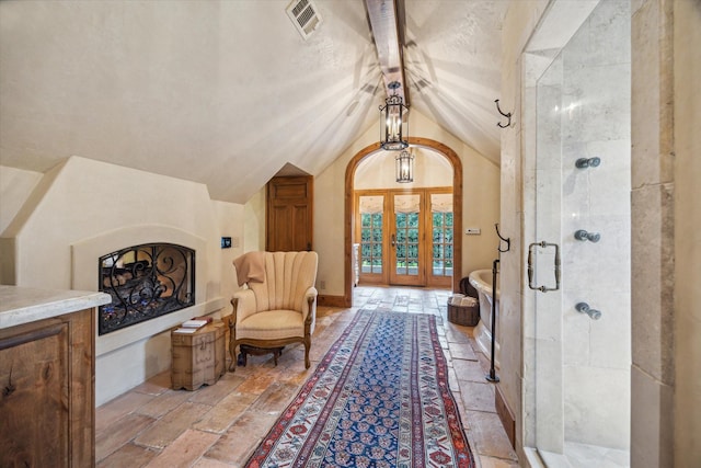 3 E Rivercrest Dr, Houston, TX 77042 - living area featuring vaulted ceiling and stone tile flooring