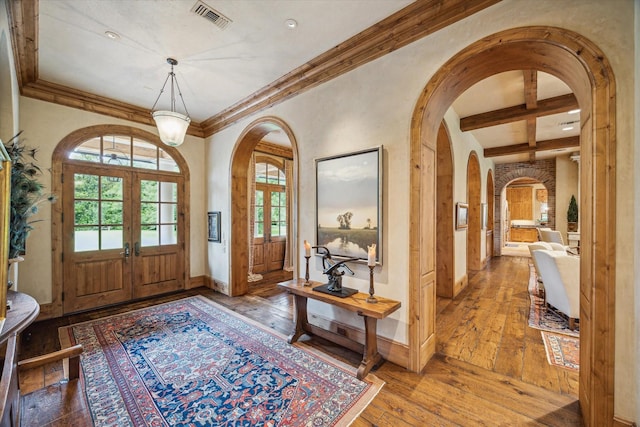 3 E Rivercrest Dr, Houston, TX 77042 - entrance foyer with french doors, wood-type flooring, arched walkways, beamed ceiling, and ornamental molding