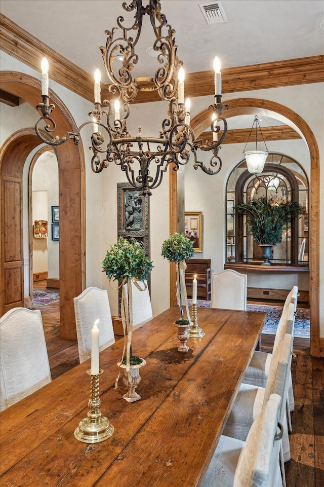 3 E Rivercrest Dr, Houston, TX 77042 - dining space featuring arched walkways, wood finished floors, ornamental molding, and a chandelier