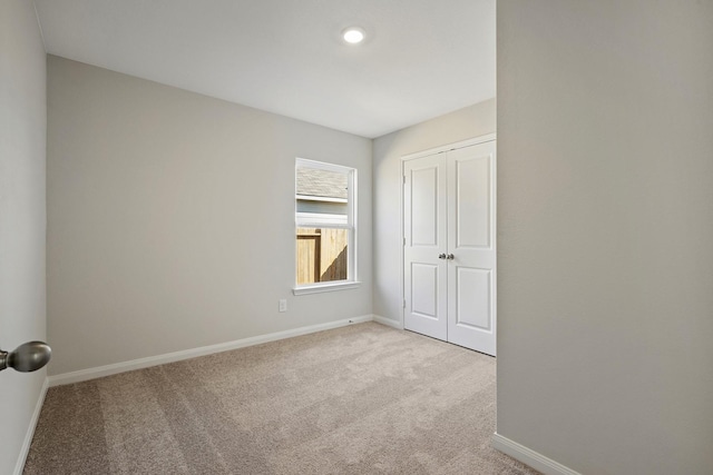 396 Tejas Trl, Waller, TX 77484 - unfurnished bedroom with light carpet, a closet, and recessed lighting