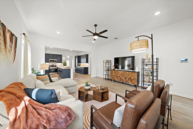 10722 Sky Creek Ln, Beasley, TX 77417 - living area with light wood finished floors, a ceiling fan, and recessed lighting