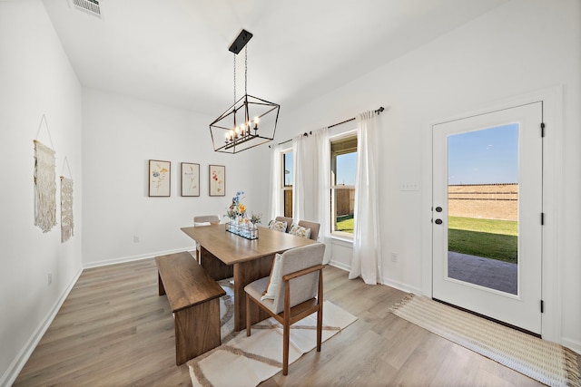 10722 Sky Creek Ln, Beasley, TX 77417 - dining area with a chandelier and light wood finished floors