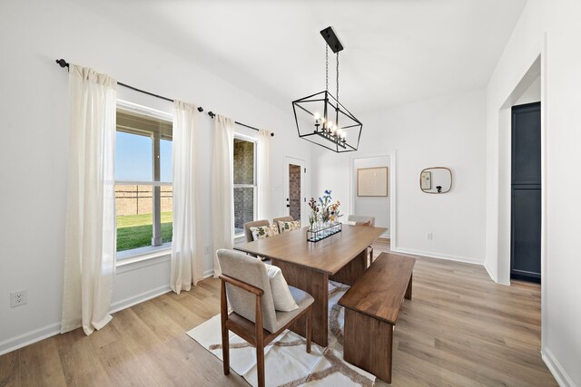 10722 Sky Creek Ln, Beasley, TX 77417 - dining space with light wood-style floors and a chandelier