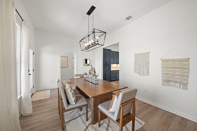 10722 Sky Creek Ln, Beasley, TX 77417 - dining area featuring light wood-style floors and a chandelier