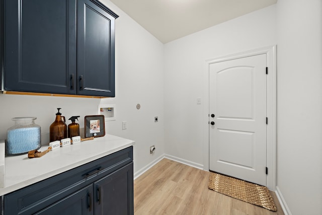 10722 Sky Creek Ln, Beasley, TX 77417 - laundry room with cabinet space, electric dryer hookup, light wood-type flooring, and hookup for a washing machine
