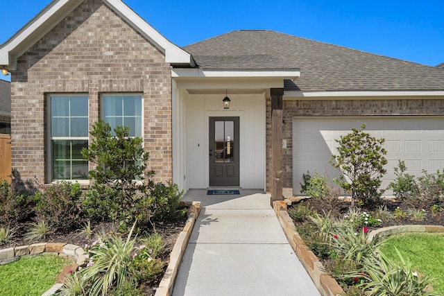 10722 Sky Creek Ln, Beasley, TX 77417 - doorway to property featuring brick siding, a shingled roof, and an attached garage
