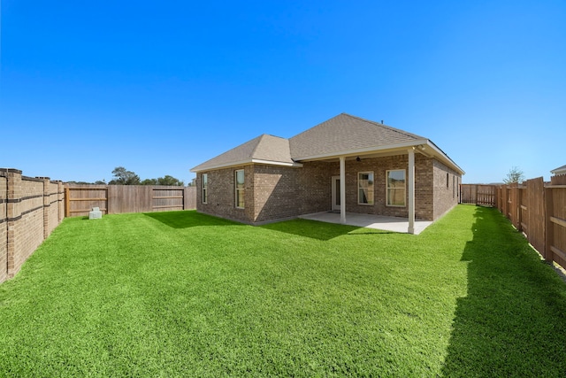 10722 Sky Creek Ln, Beasley, TX 77417 - back of property with a ceiling fan, a fenced backyard, a patio, and brick siding