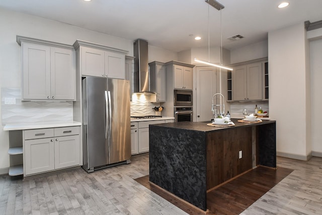 4292 Childress St, Houston, TX 77005 - kitchen featuring appliances with stainless steel finishes, open shelves, wall chimney range hood, gray cabinetry, and light wood finished floors
