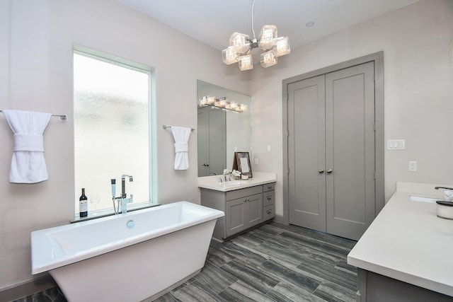 4292 Childress St, Houston, TX 77005 - full bath with two vanities, healthy amount of natural light, a freestanding tub, and a chandelier