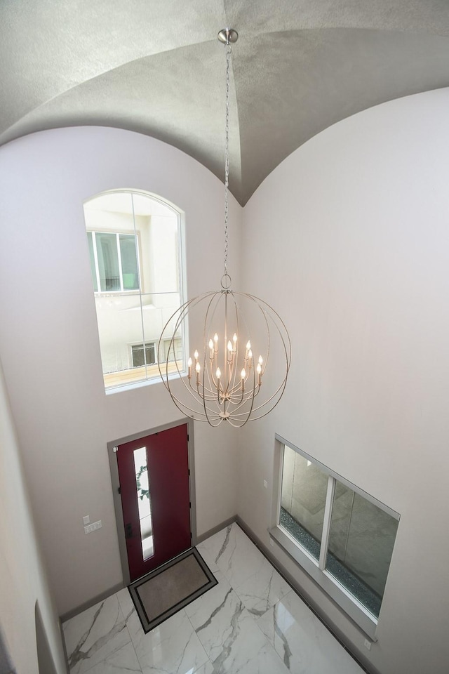 4292 Childress St, Houston, TX 77005 - entryway with marble look tiles, a chandelier, and lofted ceiling
