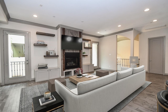 4292 Childress St, Houston, TX 77005 - living room featuring light wood-style floors, a fireplace, crown molding, and recessed lighting