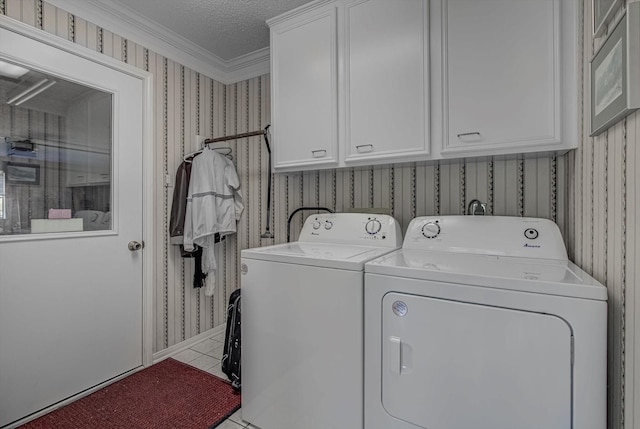 332 N Amherst Dr, West Columbia, TX 77486 - laundry area with wallpapered walls, separate washer and dryer, cabinet space, tile patterned flooring, and ornamental molding