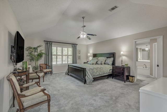 332 N Amherst Dr, West Columbia, TX 77486 - bedroom featuring light colored carpet, lofted ceiling, a textured ceiling, ensuite bathroom, and a ceiling fan