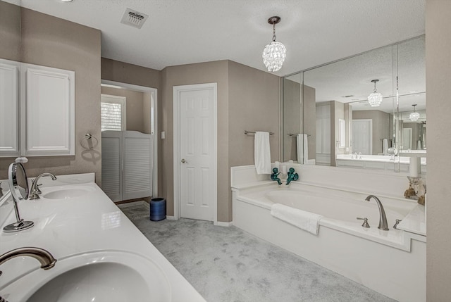332 N Amherst Dr, West Columbia, TX 77486 - bathroom with a garden tub, double vanity, and a textured ceiling