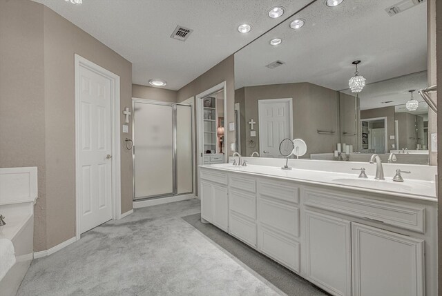 332 N Amherst Dr, West Columbia, TX 77486 - full bathroom with a shower stall, double vanity, a closet, a textured ceiling, and recessed lighting