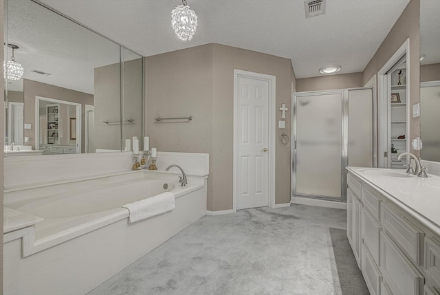 332 N Amherst Dr, West Columbia, TX 77486 - bathroom featuring a stall shower, a bath, vanity, and a textured ceiling