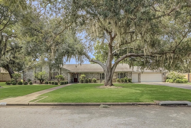332 N Amherst Dr, West Columbia, TX 77486 - view of front of house featuring stone siding, asphalt driveway, and a front yard