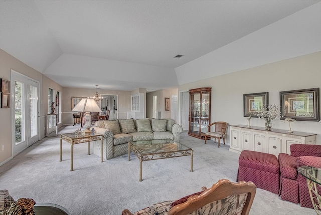332 N Amherst Dr, West Columbia, TX 77486 - living room featuring light colored carpet, vaulted ceiling, french doors, and a chandelier