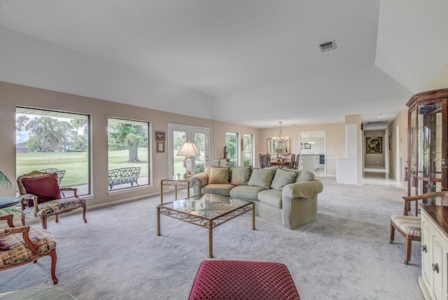 332 N Amherst Dr, West Columbia, TX 77486 - living area with light colored carpet, a chandelier, and vaulted ceiling