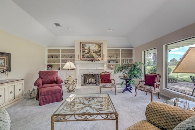 332 N Amherst Dr, West Columbia, TX 77486 - carpeted living area with lofted ceiling, a fireplace with raised hearth, and built in features