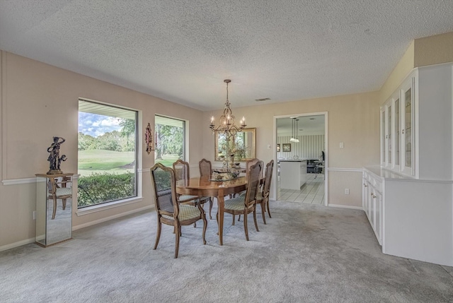 332 N Amherst Dr, West Columbia, TX 77486 - dining space featuring a chandelier, light colored carpet, and a textured ceiling