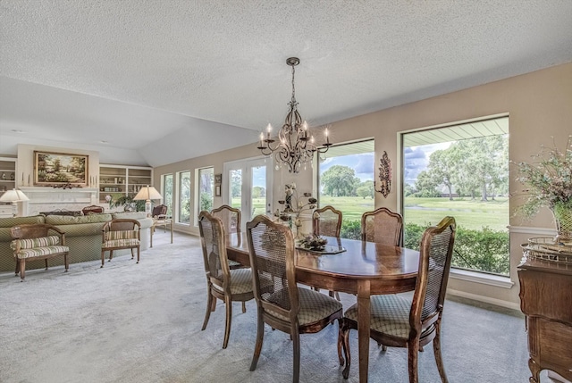 332 N Amherst Dr, West Columbia, TX 77486 - carpeted dining space with a chandelier, vaulted ceiling, a textured ceiling, and built in features