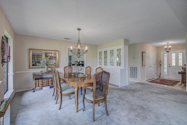 332 N Amherst Dr, West Columbia, TX 77486 - dining area with a chandelier, light colored carpet, and a textured ceiling