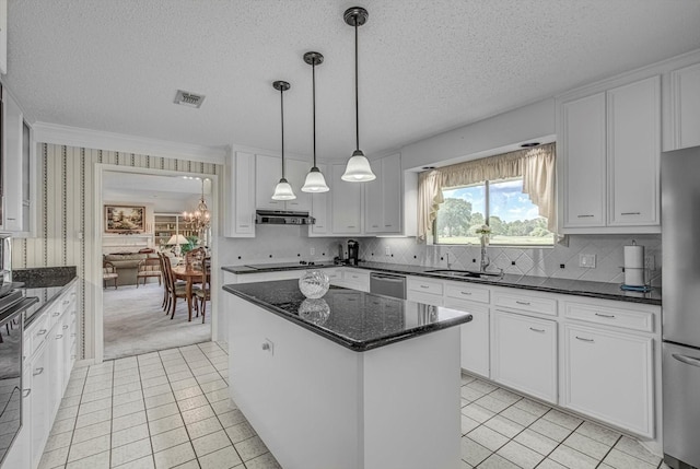 332 N Amherst Dr, West Columbia, TX 77486 - kitchen featuring a textured ceiling, appliances with stainless steel finishes, a center island, under cabinet range hood, and light tile patterned floors