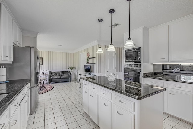 332 N Amherst Dr, West Columbia, TX 77486 - kitchen with black appliances, open floor plan, crown molding, a kitchen island, and white cabinets