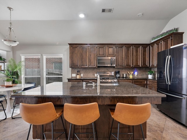 2042 Shore Breeze Dr, Pearland, TX 77584 - kitchen with appliances with stainless steel finishes, decorative backsplash, plenty of natural light, recessed lighting, and vaulted ceiling