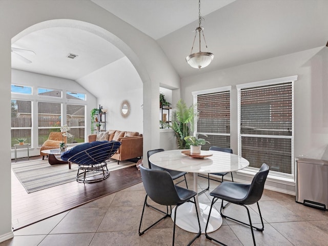 2042 Shore Breeze Dr, Pearland, TX 77584 - dining area with vaulted ceiling, arched walkways, tile patterned flooring, and ceiling fan
