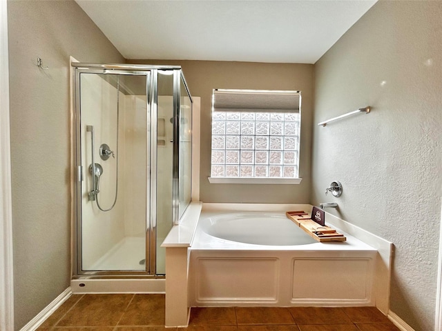2110 Sterling Oaks Dr, Rosharon, TX 77583 - bathroom featuring tile patterned floors, a shower stall, a bath, and a textured wall