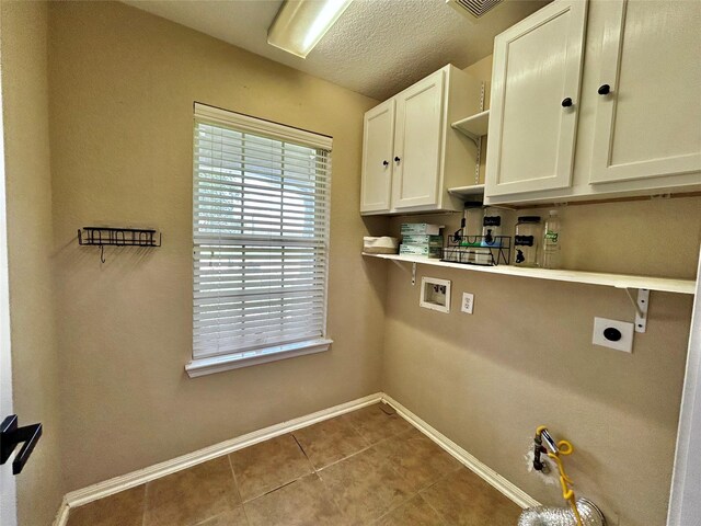 2110 Sterling Oaks Dr, Rosharon, TX 77583 - laundry area with electric dryer hookup, cabinet space, washer hookup, tile patterned flooring, and a textured ceiling
