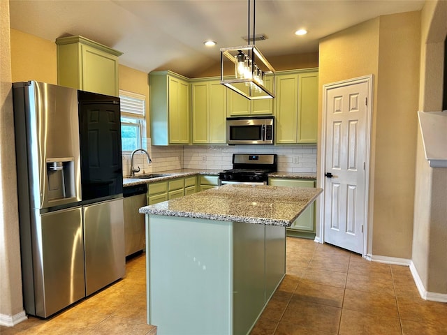 2110 Sterling Oaks Dr, Rosharon, TX 77583 - kitchen featuring appliances with stainless steel finishes, green cabinets, backsplash, light stone countertops, and a center island