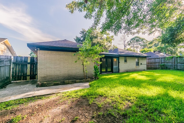 6609 Imogene St, Houston, TX 77074 - back of house featuring french doors, brick siding, and a fenced backyard