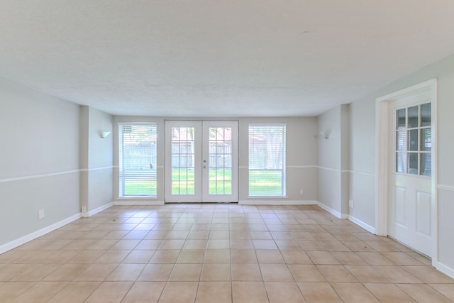 6609 Imogene St, Houston, TX 77074 - empty room featuring light tile patterned floors and baseboards