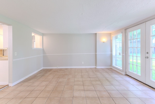 6609 Imogene St, Houston, TX 77074 - unfurnished room with plenty of natural light, a textured ceiling, and light tile patterned floors